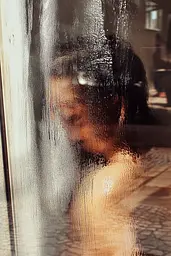 Midjourney generated image using SREF code Rustlight: A reflection of a woman in a glass door.
