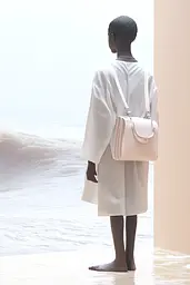 Midjourney generated image using SREF code Cremefloat: A woman in a white dress standing by the ocean.