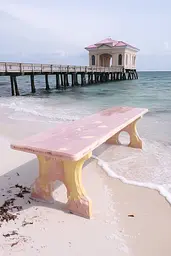 Midjourney generated image using SREF code Whisker Silks: A pink bench sitting on top of a sandy beach next to the ocean.