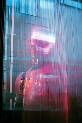 Midjourney generated image using SREF code Cyan Flux: A robot standing in front of a glass wall.