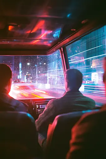 Midjourney generated image using SREF code Cyan Flux: A group of people sitting in a bus looking out the window.