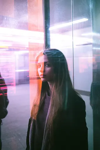 Midjourney generated image using SREF code Cyan Flux: A woman standing in front of a glass wall.