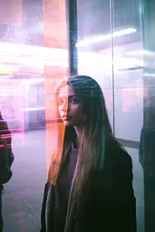 Midjourney generated image using SREF code Cyan Flux: A woman standing in front of a glass wall.