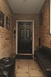 Midjourney generated image using SREF code Hushframe: A black couch sitting in front of a black door.