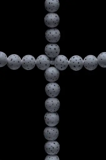 Midjourney generated image using SREF code Squelchloom: A cross made out of golf balls on a black background.