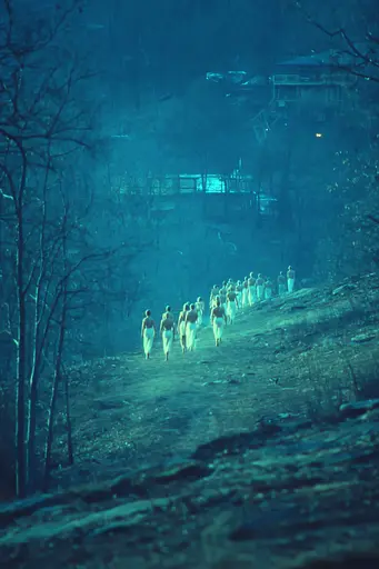 Midjourney generated image using SREF code Blue Velvet: A group of people walking down a dirt road at night.