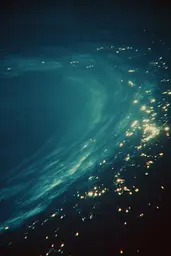 Midjourney generated image using SREF code Blue Velvet: A view of the ocean at night from an airplane window.