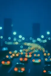Midjourney generated image using SREF code Blue Velvet: A blurry image of a busy city street at night.