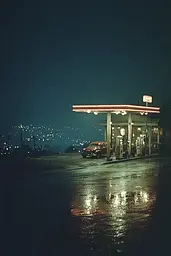Midjourney generated image using SREF code Nebuloom: A gas station at night with a car parked in front of it.