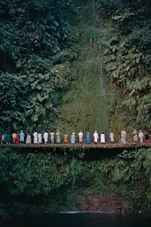 Midjourney generated image using SREF code Hushed Loomlight: A group of people standing on a bridge in front of a waterfall.