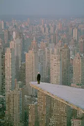 Midjourney generated image using SREF code Hushed Loomlight: A man standing on top of a tall building in a city.