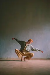 Midjourney generated image using SREF code Hushed Loomlight: A man in a striped shirt and tan pants is dancing.