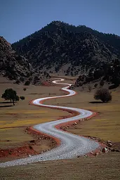 Midjourney generated image using SREF code Pyrognome: A winding road in the middle of a grassy field.