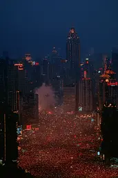Midjourney generated image using SREF code Plushgrim: A large crowd of people in the middle of a city at night.
