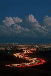 Midjourney generated image using SREF code Plushgrim: A long exposure shot of a city at night.
