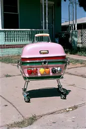 Midjourney generated image using SREF code GlimmerDial: A pink cart with fruit on it sitting on a sidewalk.