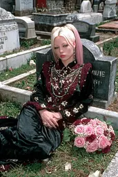 Midjourney generated image using SREF code GlimmerDial: A woman sitting on a grave with a bouquet of flowers.