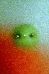Midjourney generated image using SREF code Chromoshred: a close up of a person's face with a green ball on it