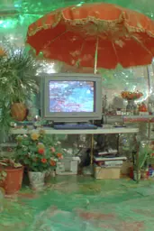 Midjourney generated image using SREF code Chromoshred: A television sitting on top of a table under an umbrella.