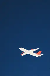 Midjourney generated image using SREF code ChromeVellum: A white and red airplane flying through a blue sky.