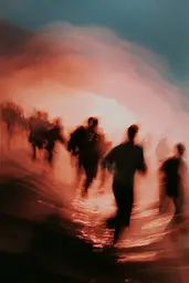 Midjourney generated image using SREF code Blurloom: A group of people running on a beach at sunset.