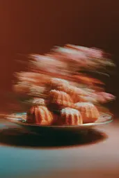 Midjourney generated image using SREF code Blurloom: A plate of donuts sitting on top of a table.