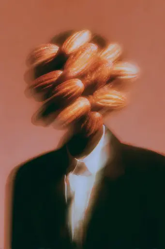 Midjourney generated image using SREF code Blurloom: A man in a suit with a bunch of bread on his head.