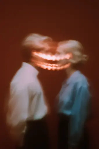Midjourney generated image using SREF code Blurloom: A man and a woman standing next to each other in front of a red wall.