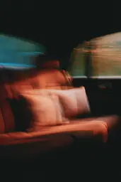 Midjourney generated image using SREF code Blurloom: A blurry image of a person sitting in a car.