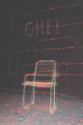 Midjourney generated image using SREF code Chromatic Lineage: A chair sitting in front of a brick wall with the word OME written on it.