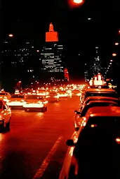 Midjourney generated image using SREF code Amber Memoirs: A city street filled with lots of traffic at night.