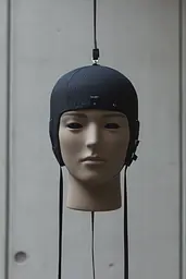 Midjourney generated image using SREF code Chiaroscuro Chronicles: A mannequin head wearing a black helmet with ear flaps.