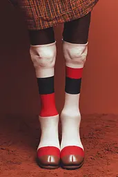 Midjourney generated image using SREF code Ballooned Identity: A woman wearing a pair of white socks with red and black stripes.